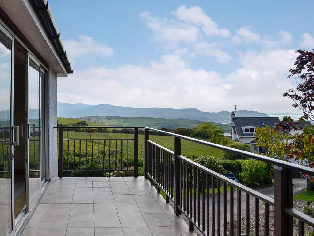 a balcony with a view of the mountains at Pathacres in Mochdre