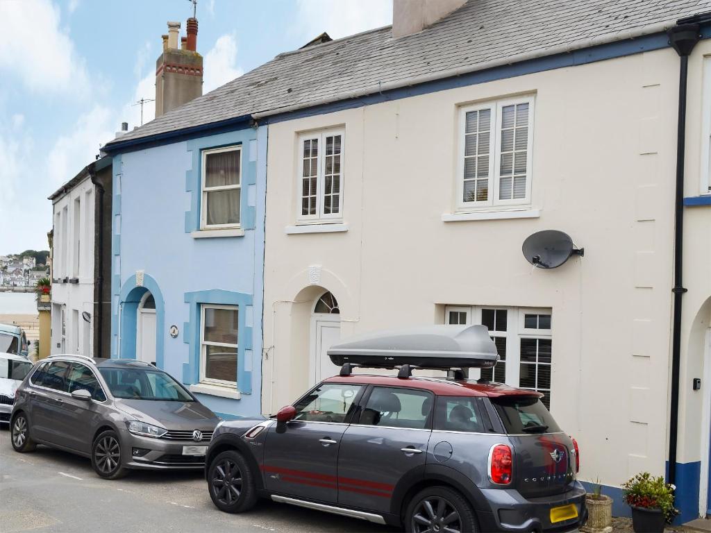 a car parked in front of a blue and white house at Anchor Cottage in Instow