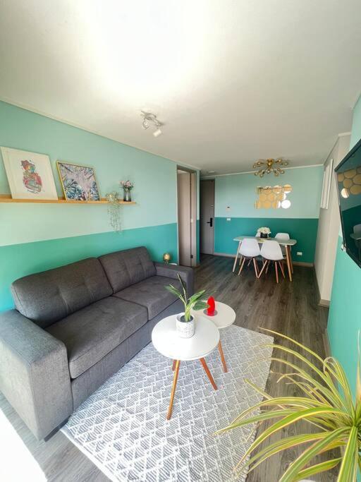 a living room with a couch and a table at Apartamento General Mackenna B&E in Santiago