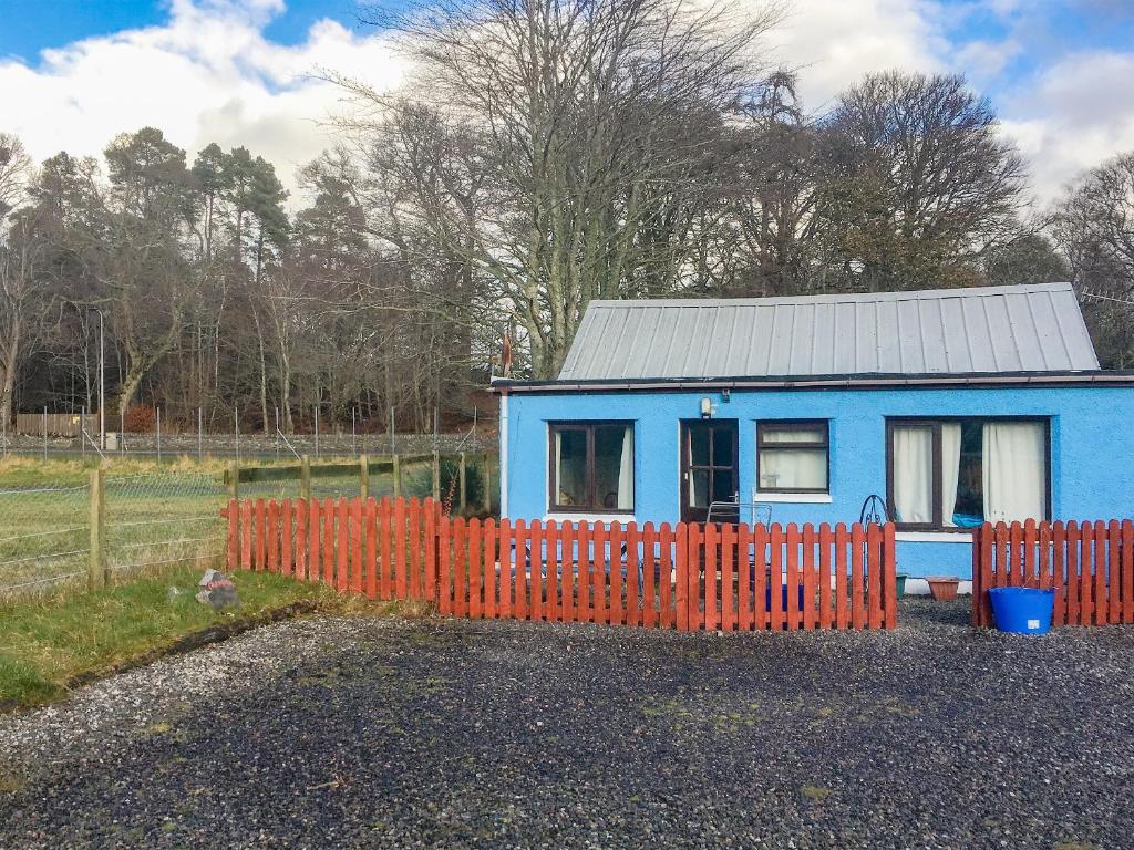 a blue tiny house with a red fence at The Cairngorms - Uk7096 in Contin