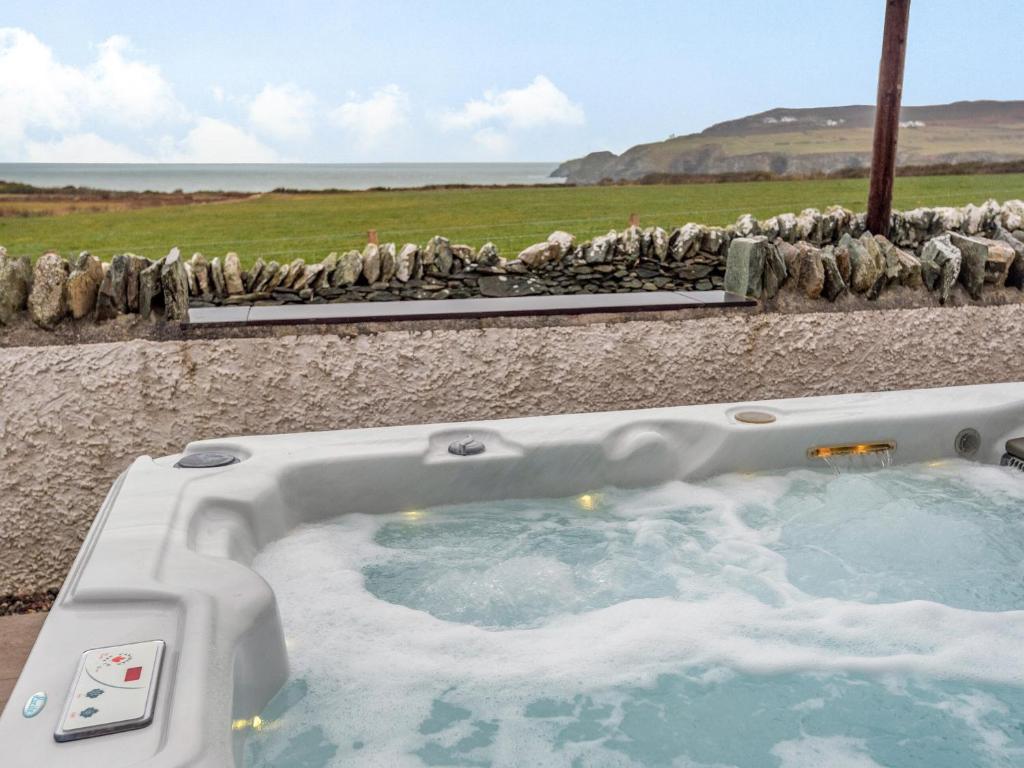 a jacuzzi tub with a view of a field at Seascape in Holyhead