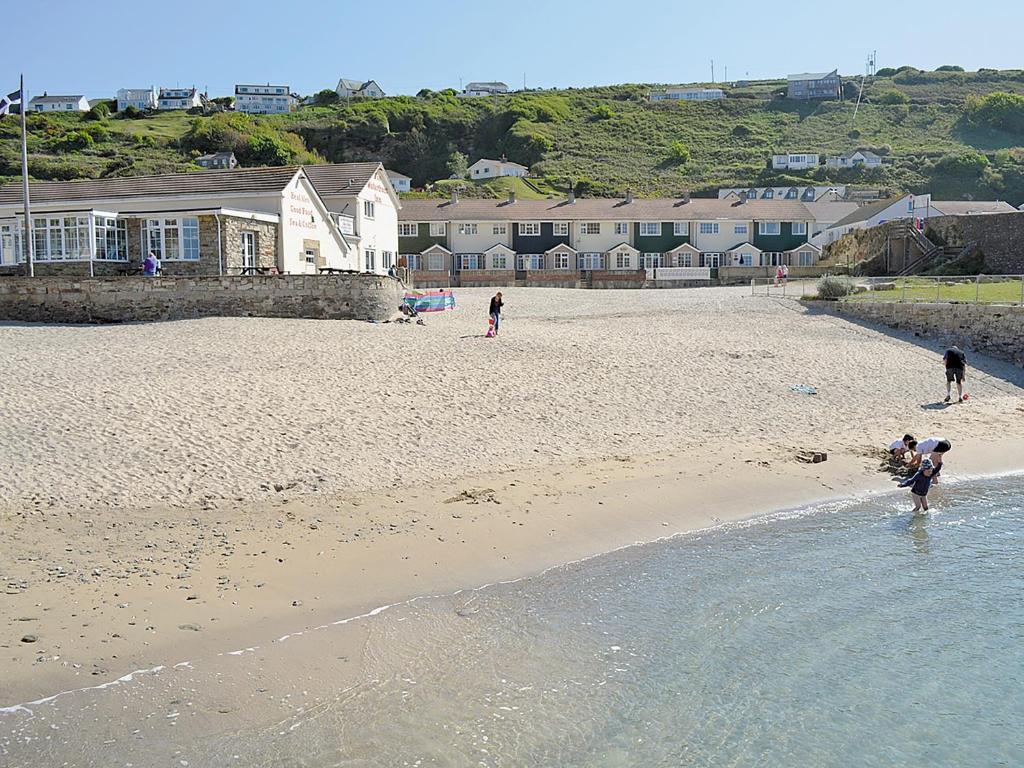 a group of people playing on the beach at Seagull Cottage in Portreath