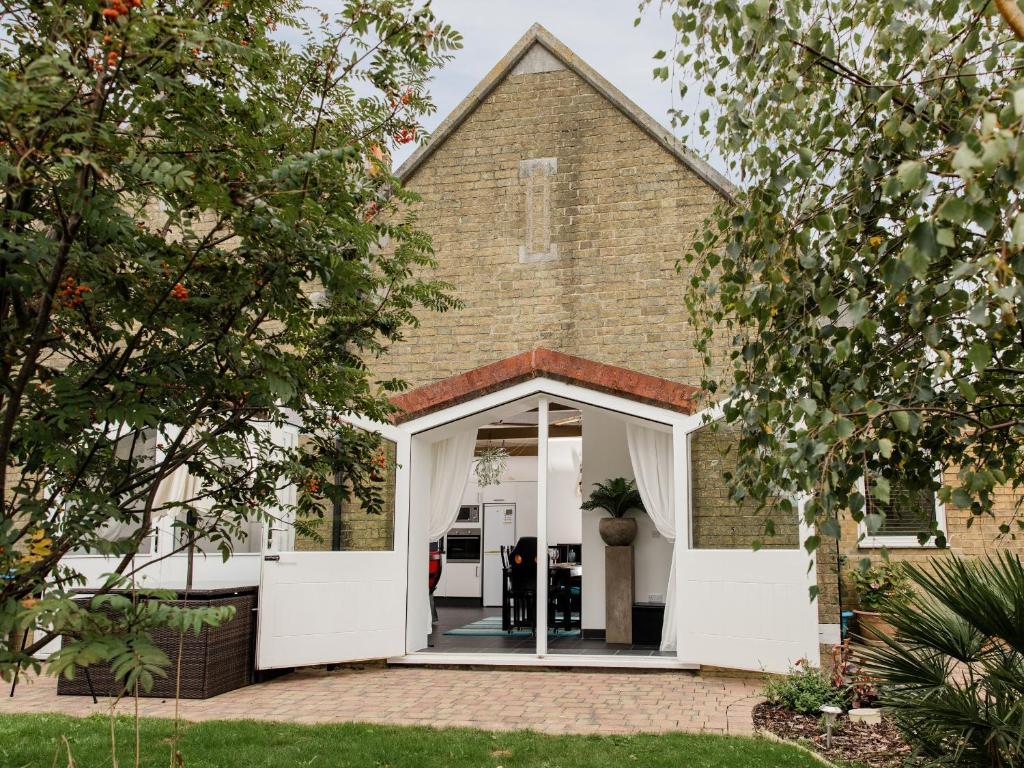 an open door into a church with trees at The Boathouse in East Cowes