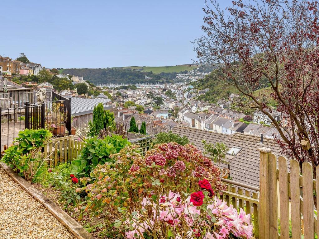 a view of a city from a garden with flowers at Tell Tails in Dartmouth