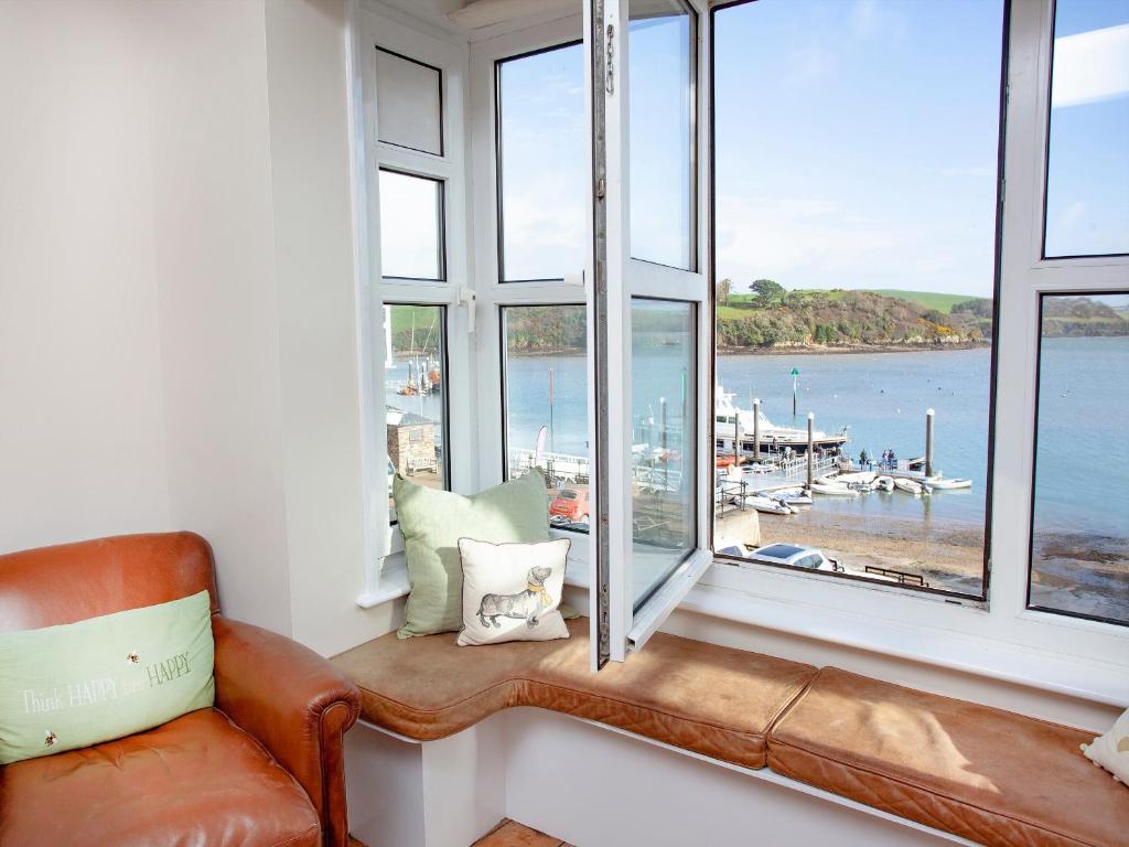 a window seat with a couch and a view of a marina at The Lookout in Salcombe