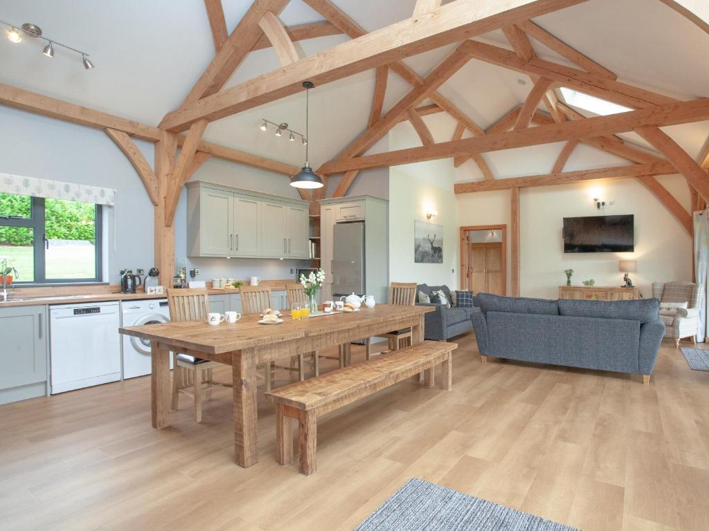 a large kitchen and dining room with a wooden table at Oaklands in Stockleigh Pomeroy