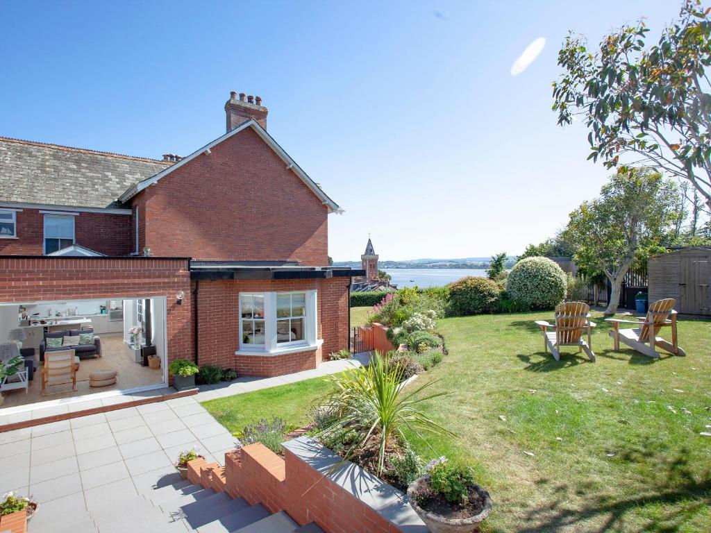 a house with a yard with a patio at Haldon View in Lympstone