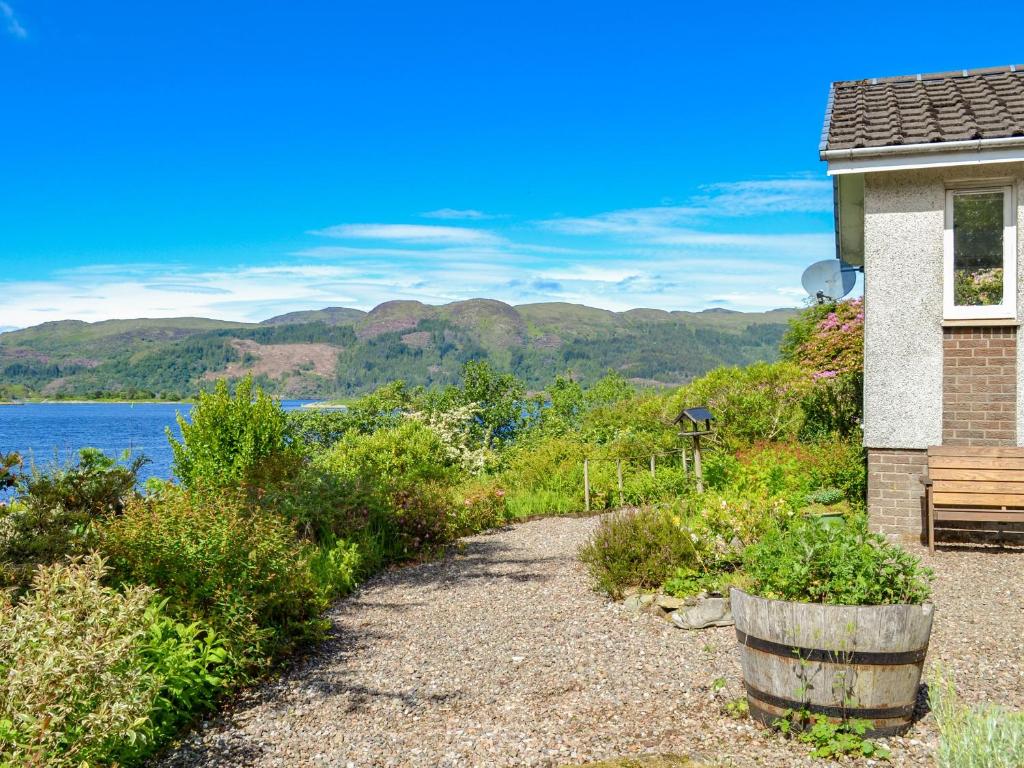 a path to a house with a view of the water at Dunyvaig in Colintraive