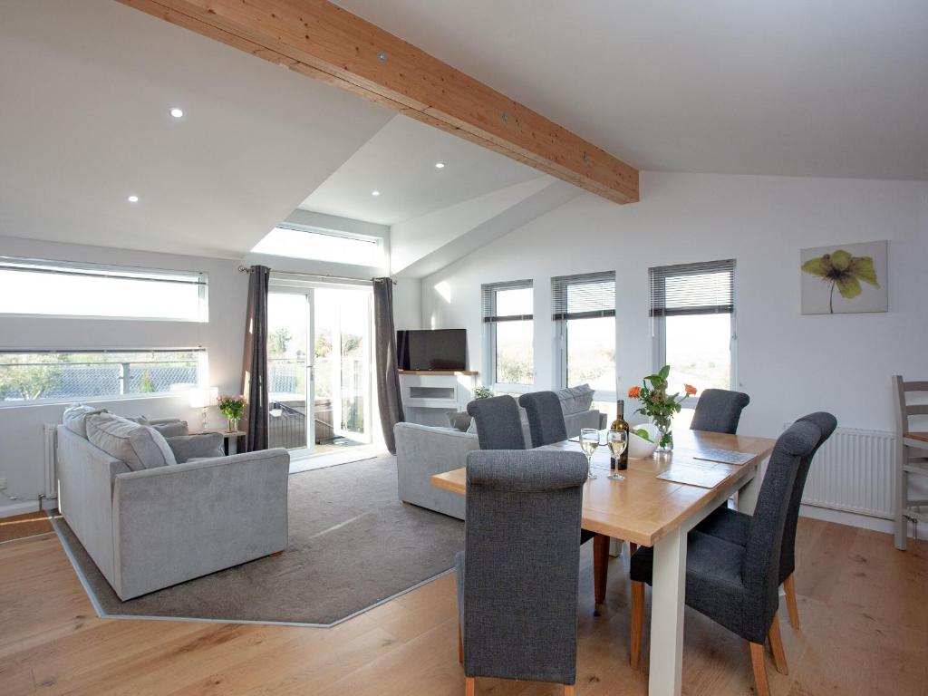 a living room with a wooden table and chairs at Moornook 7-uk36703 in Newton Abbot