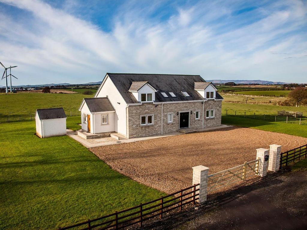 a large house in the middle of a field at Wheatfield House in Kilmaurs