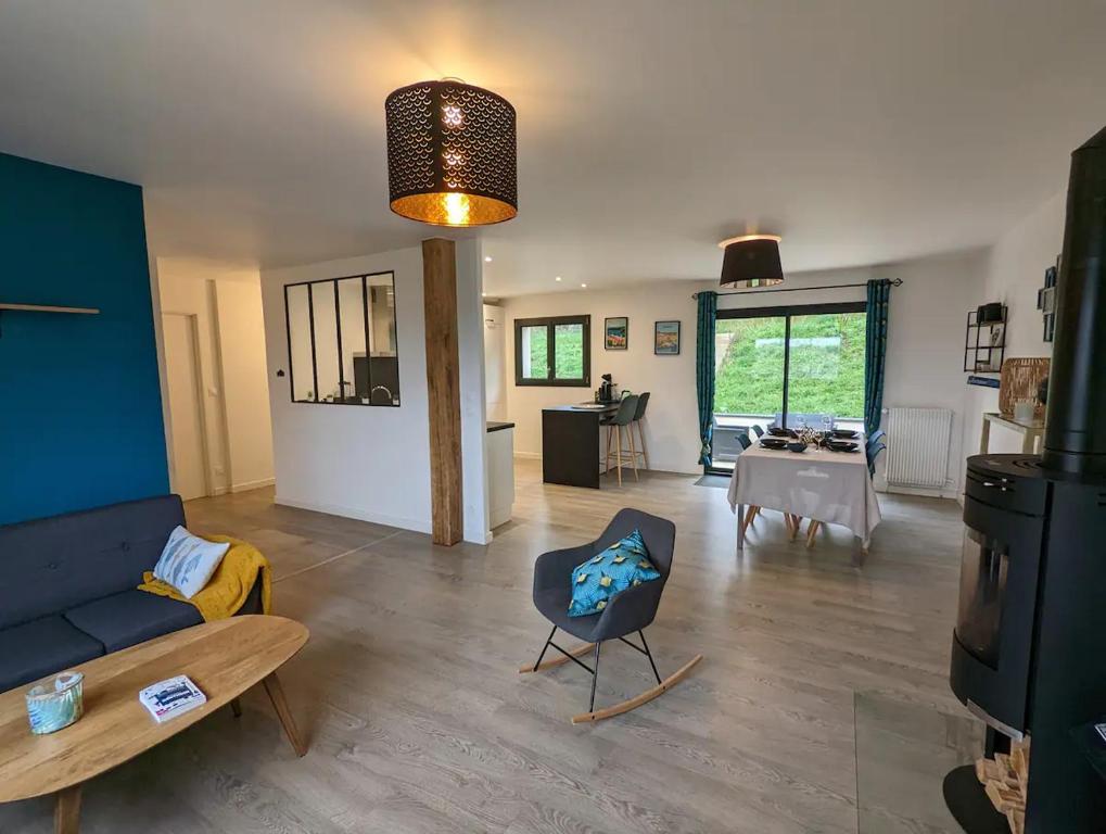 a living room with a couch and a chair at Maison au calme dominant la ville d&#39;Evreux in Évreux