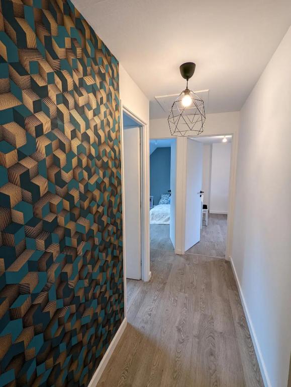 a hallway with a wall with a large wooden wall at Maison au calme dominant la ville d&#39;Evreux in Évreux