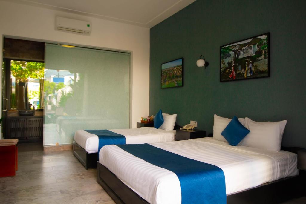 Postel nebo postele na pokoji v ubytování Hilary Boutique Villa Hội An