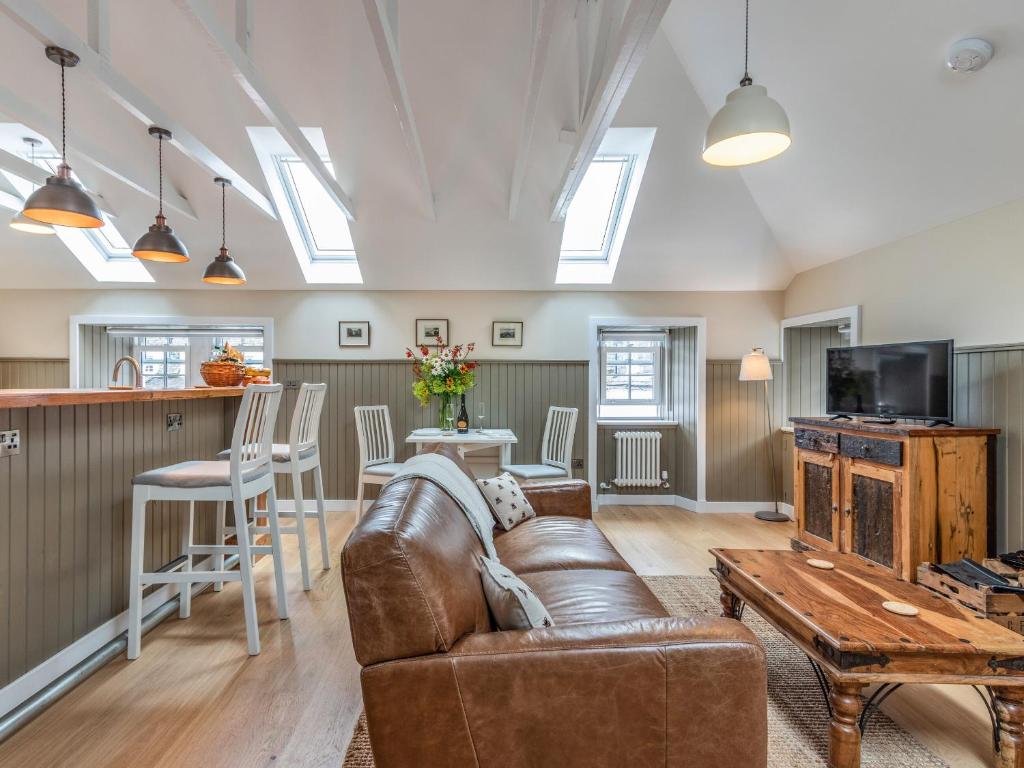 a living room with a couch and a table at The Granary - Uk34899 in Dunira