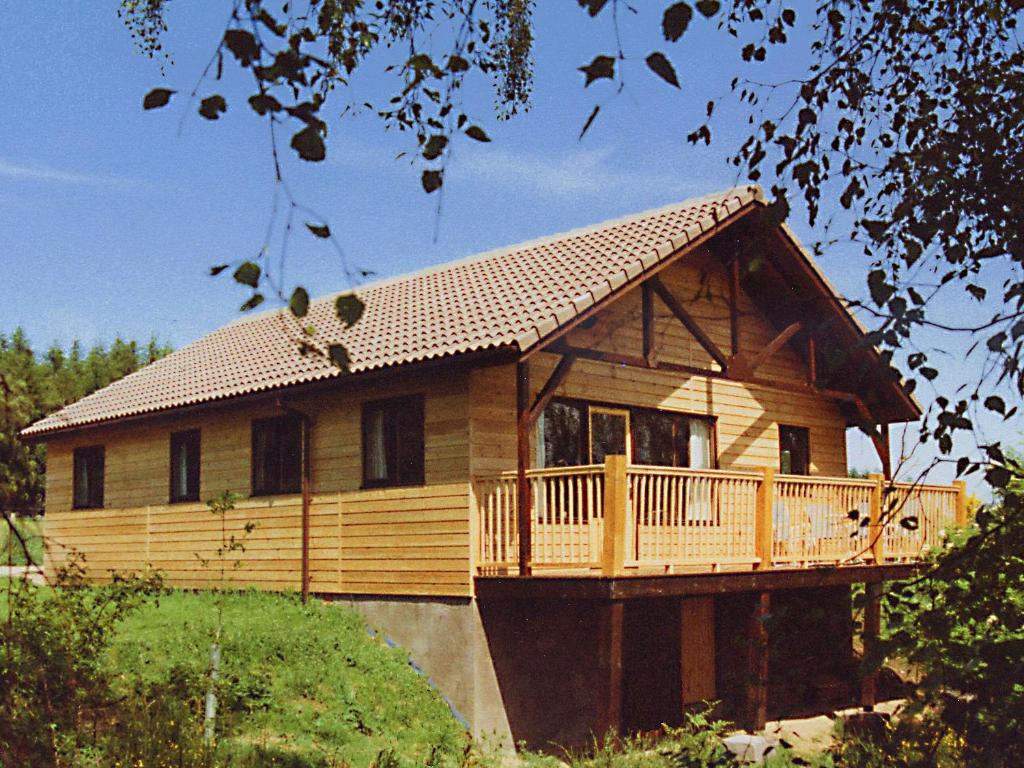 a large wooden house with a large deck at Treetops Lodge - Uk30556 in Urchany