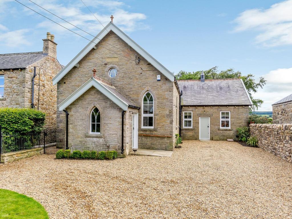 an old stone house with a driveway in front of it at The Old Chapel in Slaley