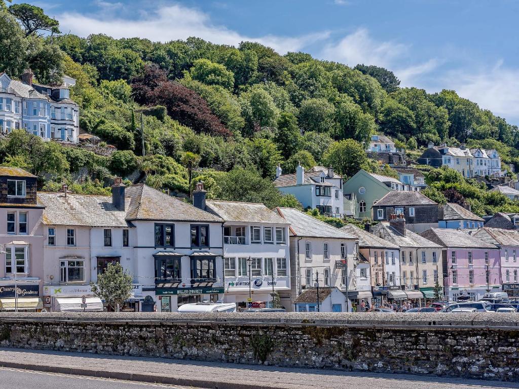 a town on a hill with houses and a river at Water View in Looe