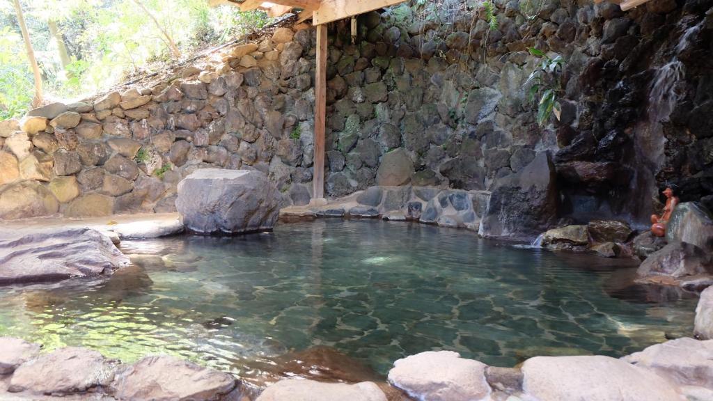 a large pool of water in a rock wall at Kappa Tengoku in Hakone