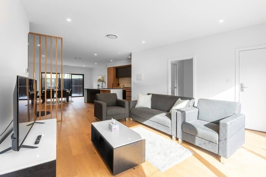 a living room with two couches and a tv at Three bedroom Townhouse in O'connor ACT in Canberra