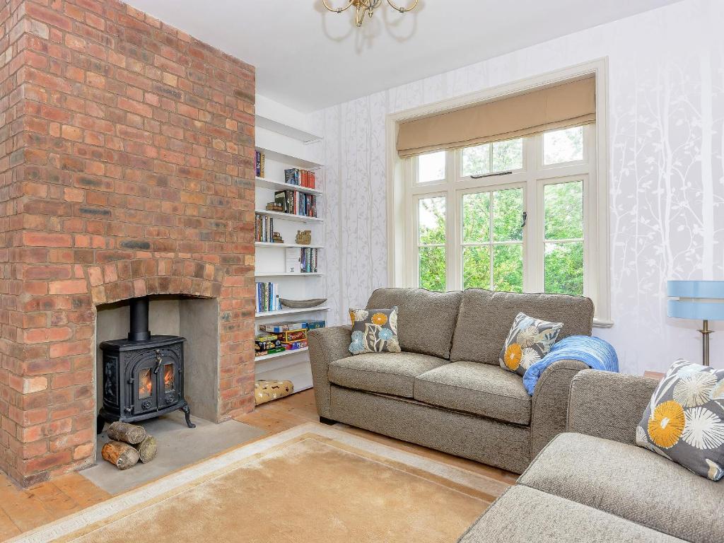 a living room with a couch and a fireplace at Station House in Millers Dale