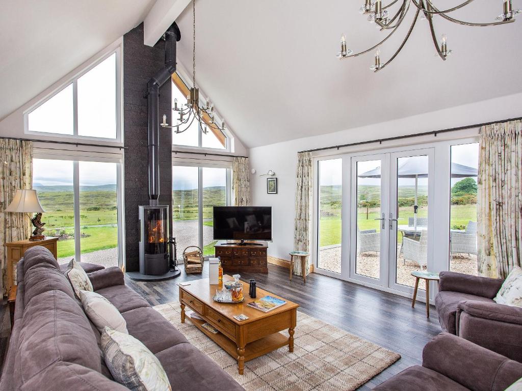 a living room with a couch and a tv at Morven View in Dunbeath