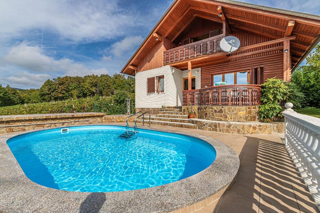 a house with a swimming pool in front of a house at Pool Villa Adonis - Happy Rentals in Semič