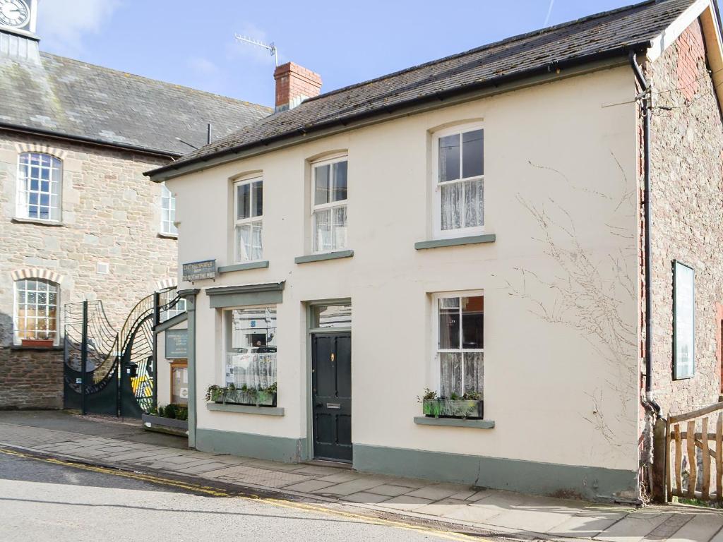 a white building on the side of a street at The Mill House, The Square in Talgarth