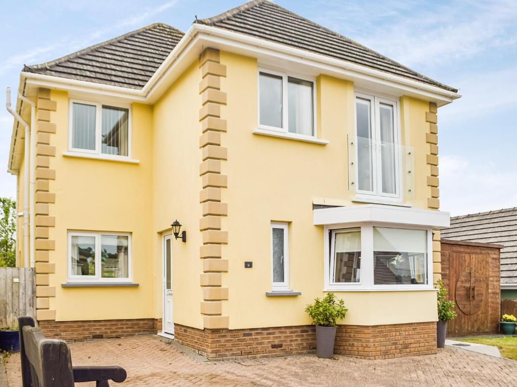 a house with yellow paint on it at Trondra House in Ferryside