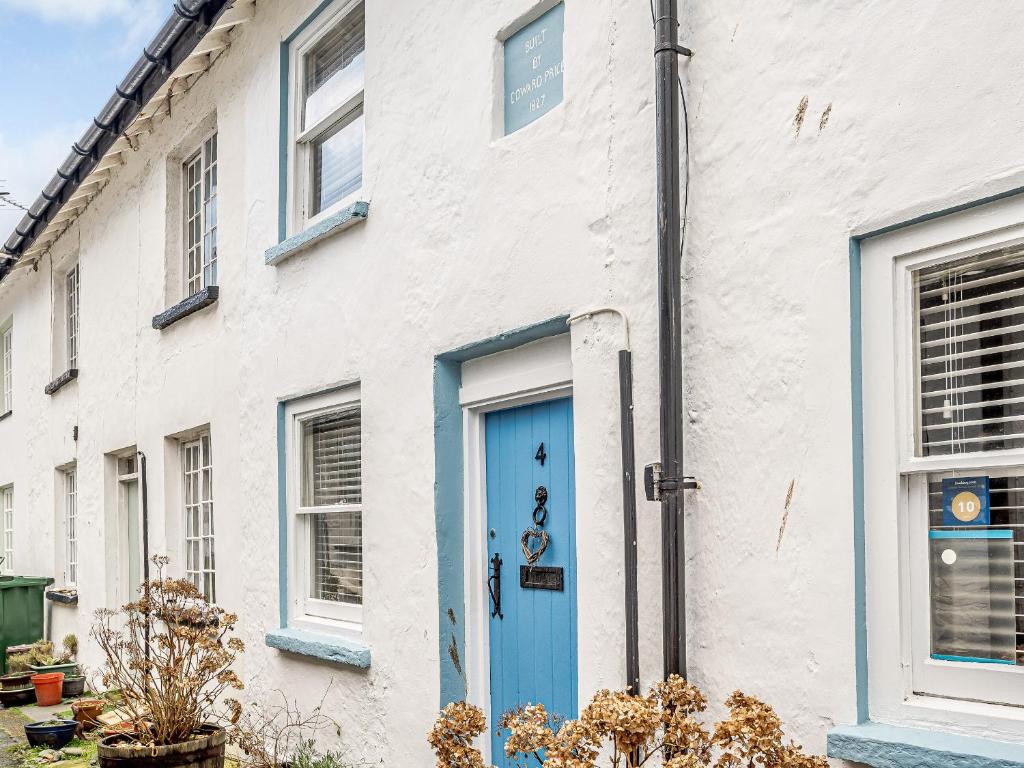 a white brick house with a blue door at Sunny Shores - Uk32245 in Aberdyfi