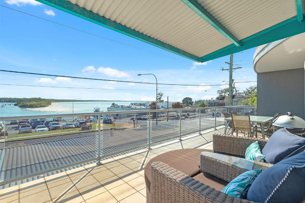 a balcony with chairs and a view of a highway at Jervis Bay Vista in Huskisson