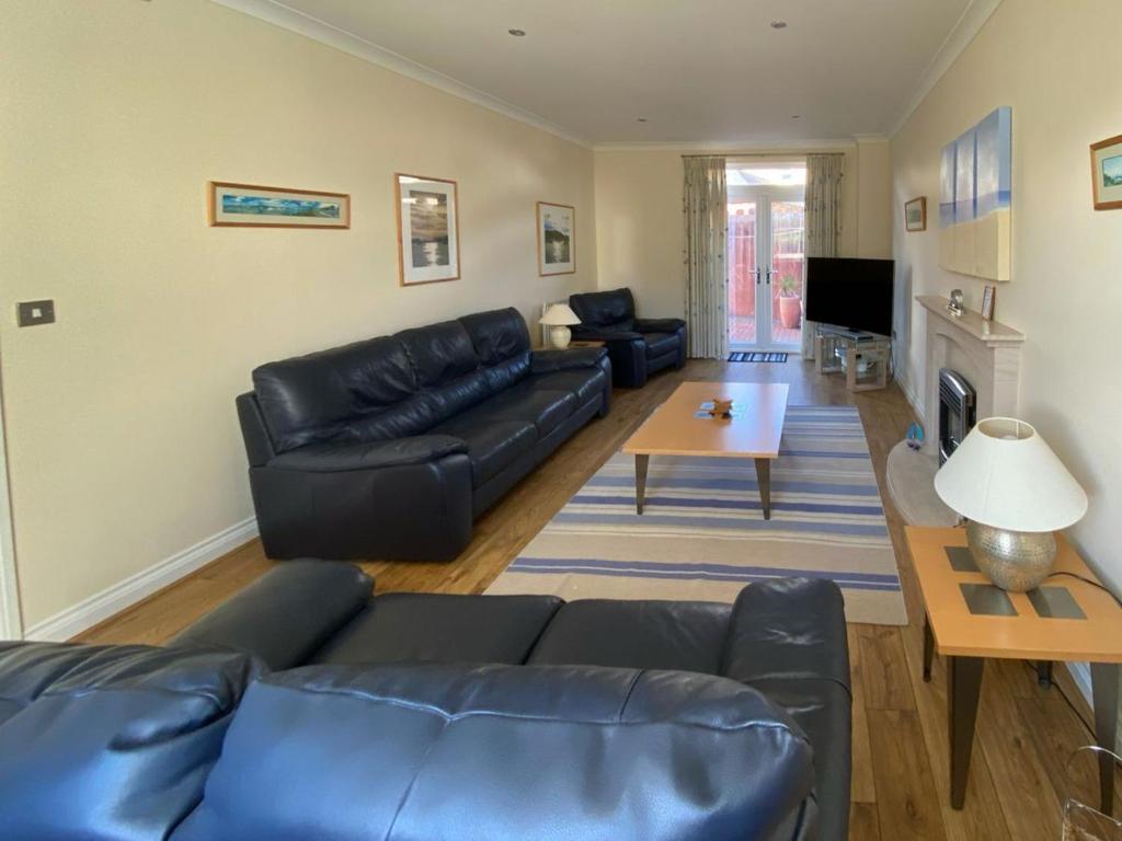 a living room with a couch and a table at 5 Shoreside in Shaldon