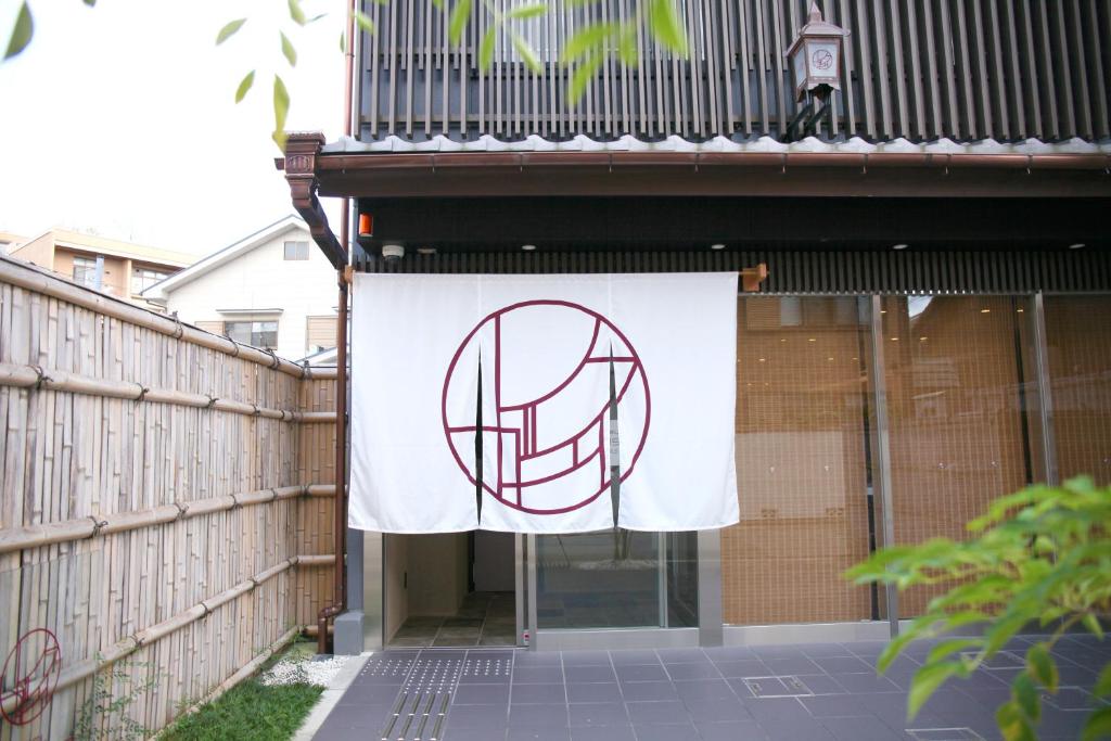 a flag hanging on the side of a building at HOTEL LEGASTA KYOTO SHIRAKAWA SANJO in Kyoto