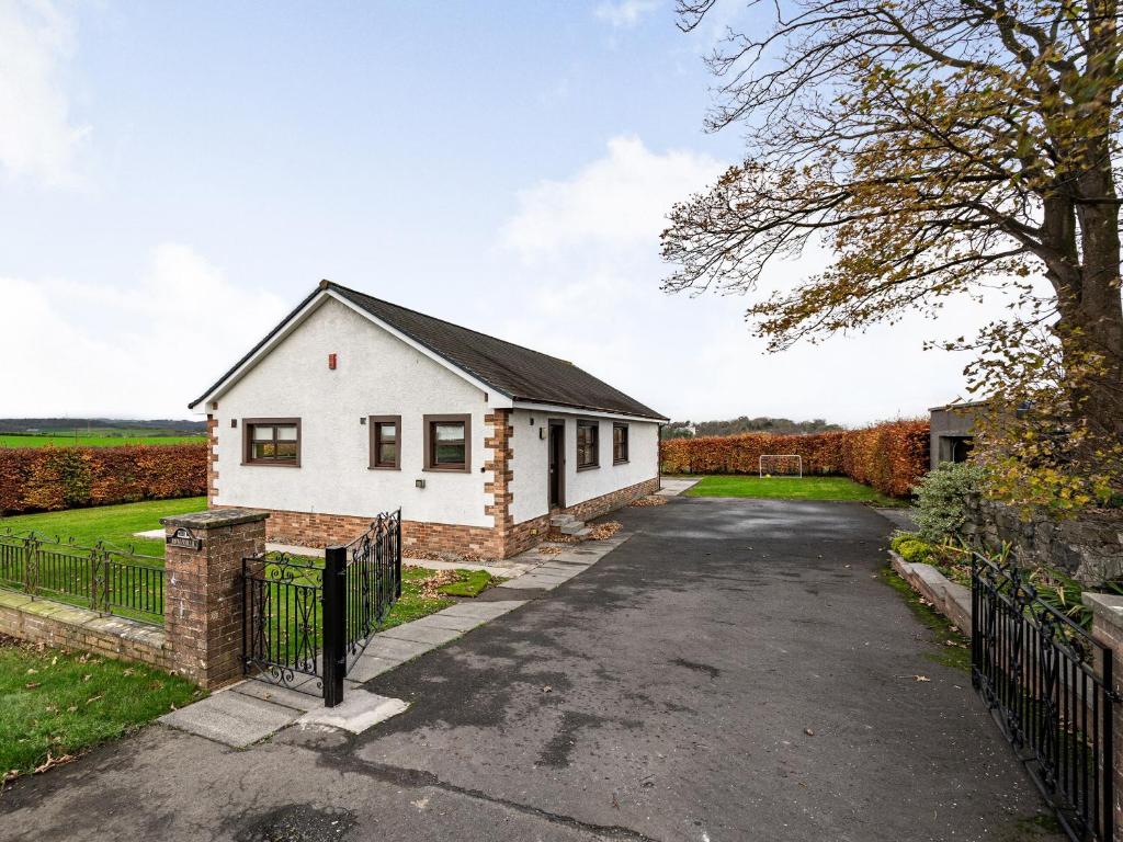 a house in the middle of a driveway at Rowan Muir in Springside