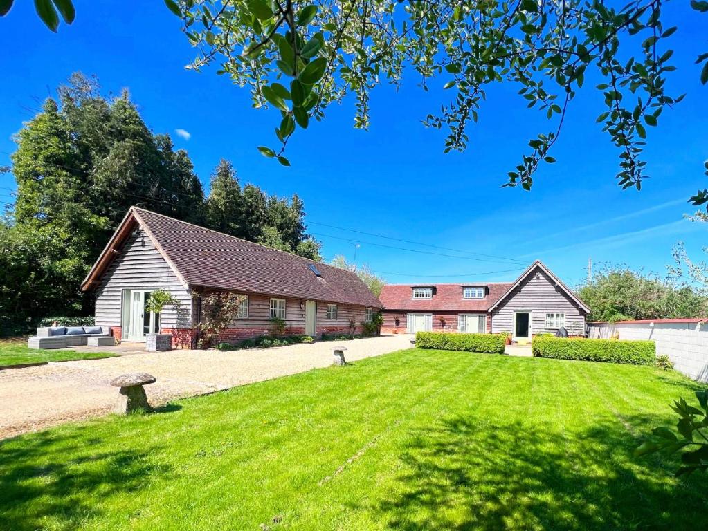 a house with a large lawn in front of it at The Old Stables 1 in Winterslow