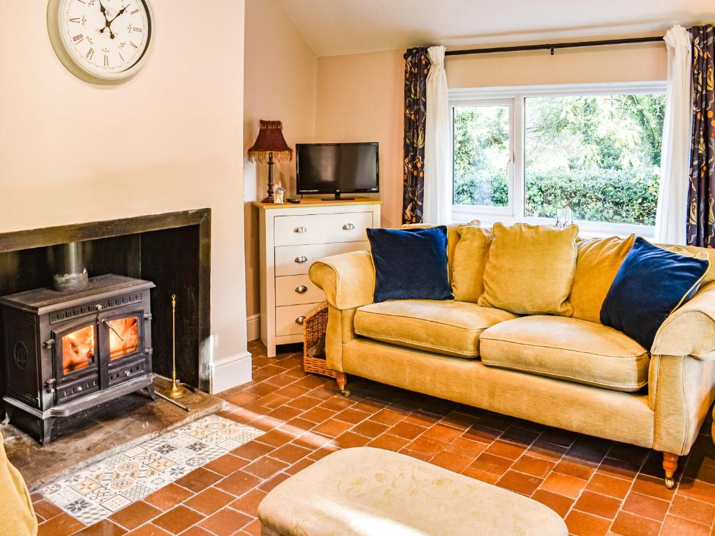 a living room with a couch and a fireplace at Brookdale in Malpas