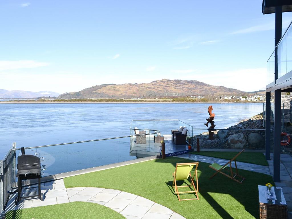 a person is walking on the deck of a boat on the water at 4 Dolphins in Connel