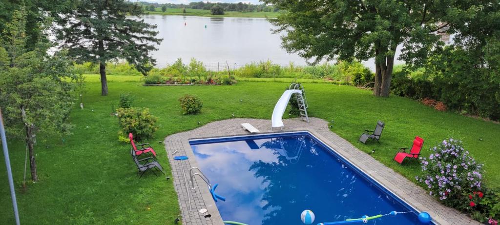 an overhead view of a swimming pool with a water slide at Villa Delrose Waterfront - No party in Montreal
