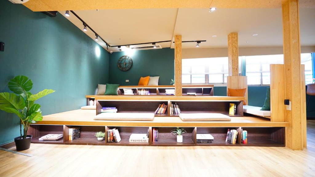 a room with green walls and wooden shelves at RF Hotel - Zhongxiao in Taipei