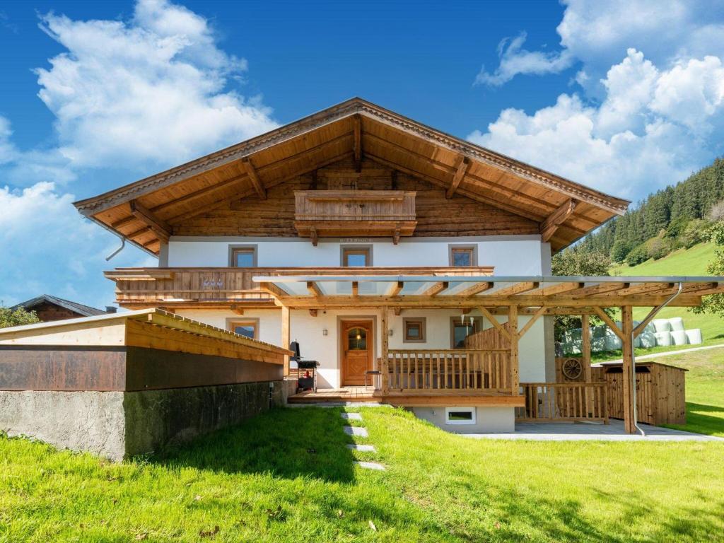 a house with a wooden roof at beautifully renovated farmhouse Stoanerbauer with a wonderful view in Dorf