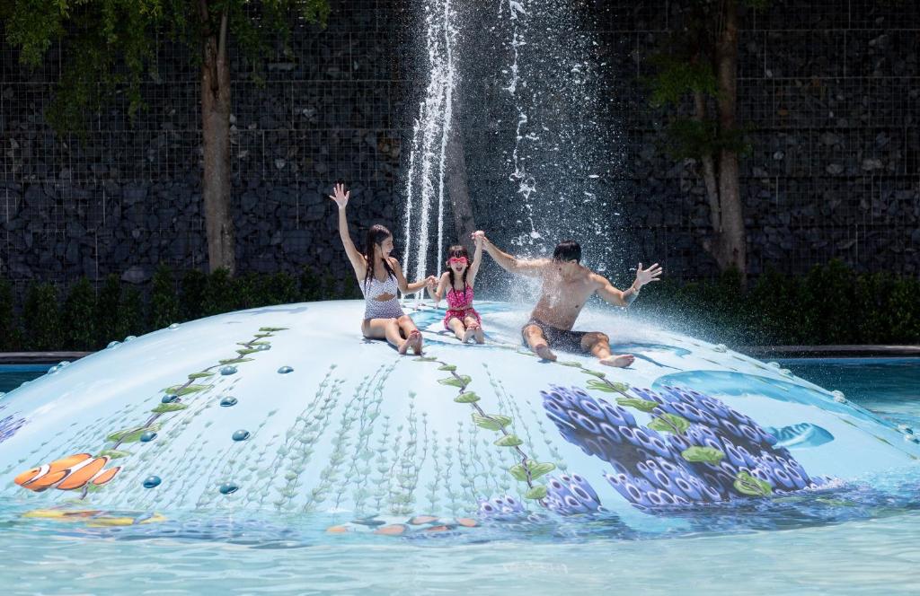 a group of people sitting on top of a fake waterfall at SO/ Sofitel Hua Hin in Cha Am