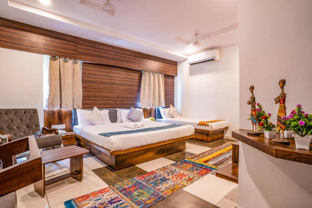 a hotel room with a bed and a couch at Hotel Naman in Udaipur