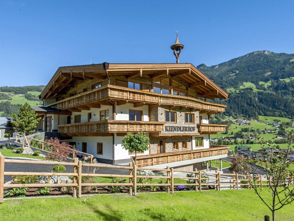 a large wooden building on top of a hill at Farmhouse in Schwendau with Ski Storage in Hippach