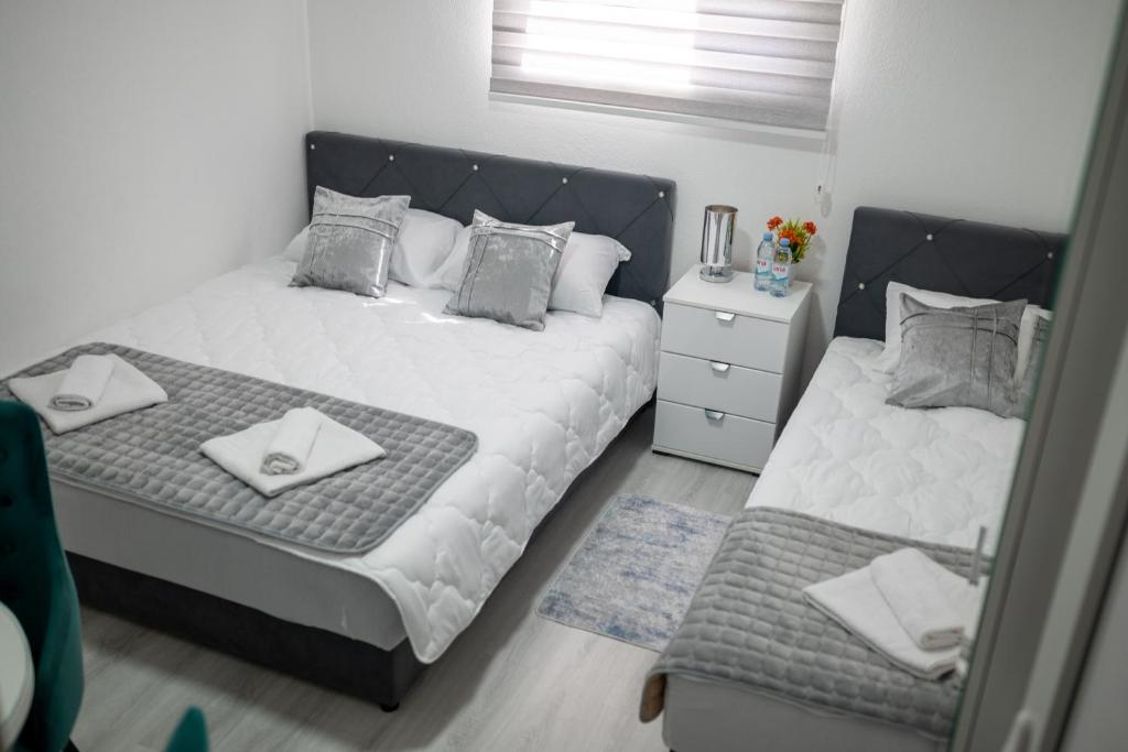 a bedroom with two beds and a mirror at Felicita Apartments Brcko in Brčko