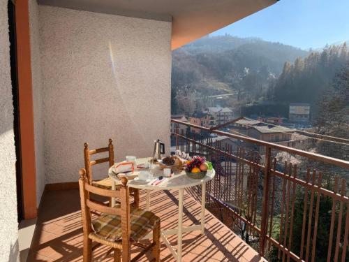 a table and chairs on a balcony with a view at SKI AND OUTDOOR HOUSE in Frabosa Sottana
