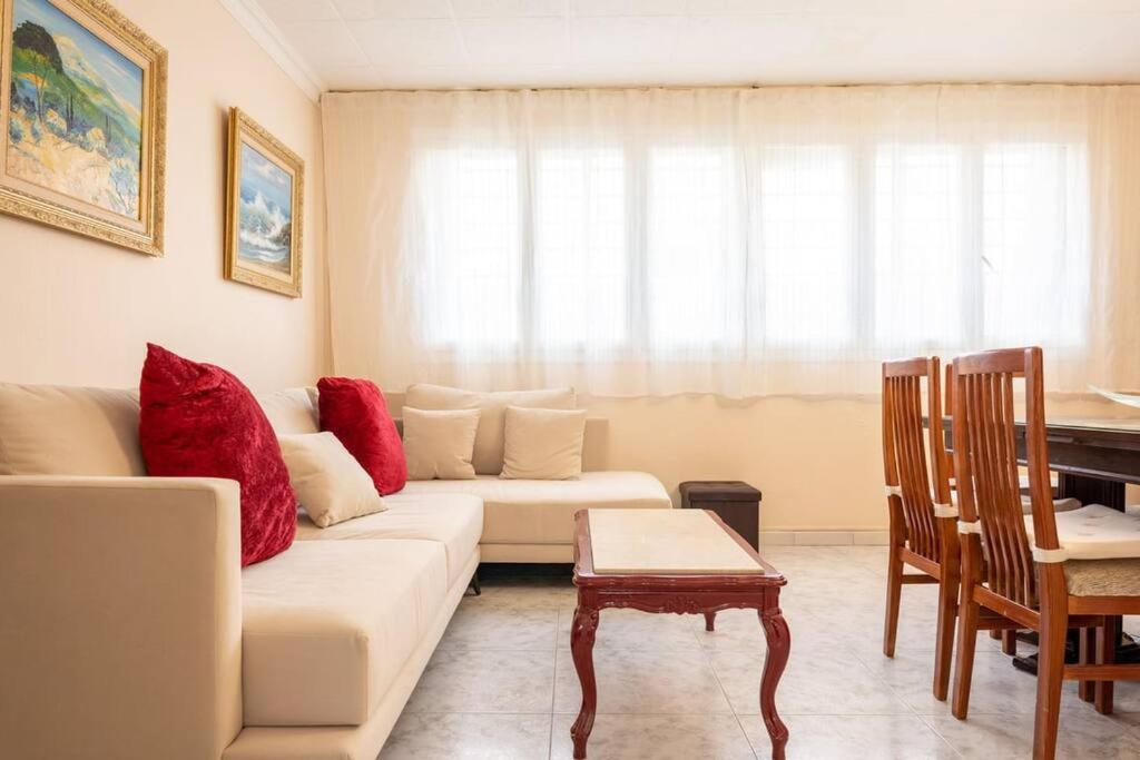 a living room with a couch and a table at GuestReady - Vintage Elegance in Catalonia in Cornellà de Llobregat