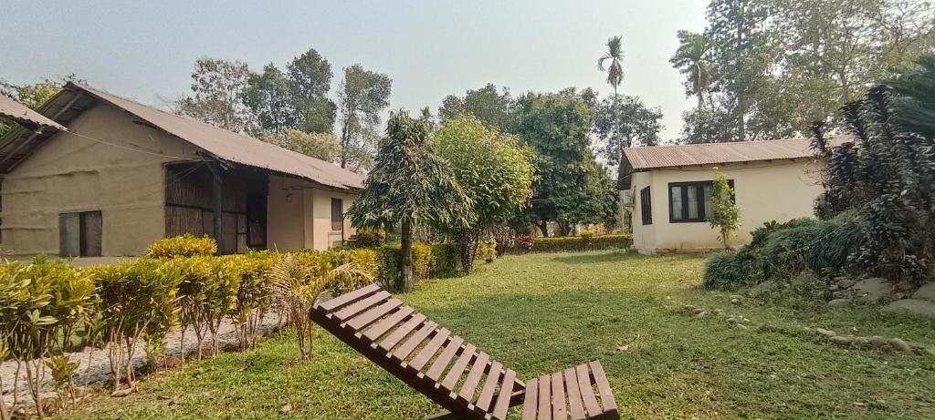 a bench sitting in the yard of a house at Hotel Tharu Garden And Beer Bar in Chitwan