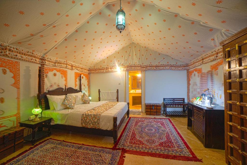 a bedroom with a bed in a room at Hilton Jaisalmer Desert camp in Sām
