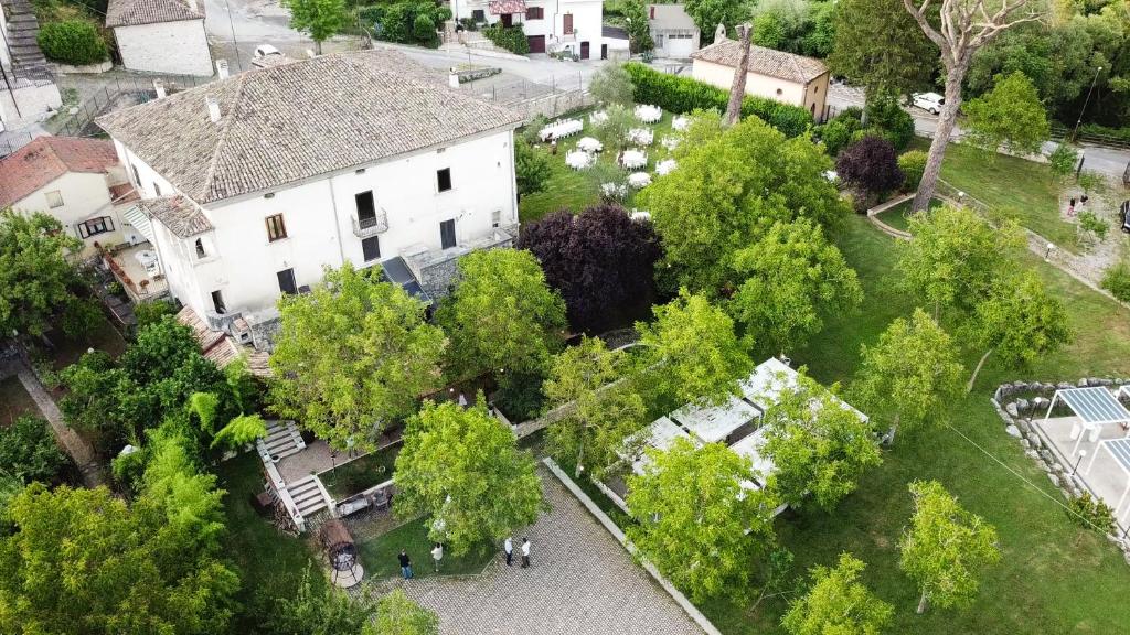 an overhead view of a large white house with trees at Palazzo de' Farrocco in Cerro al Volturno