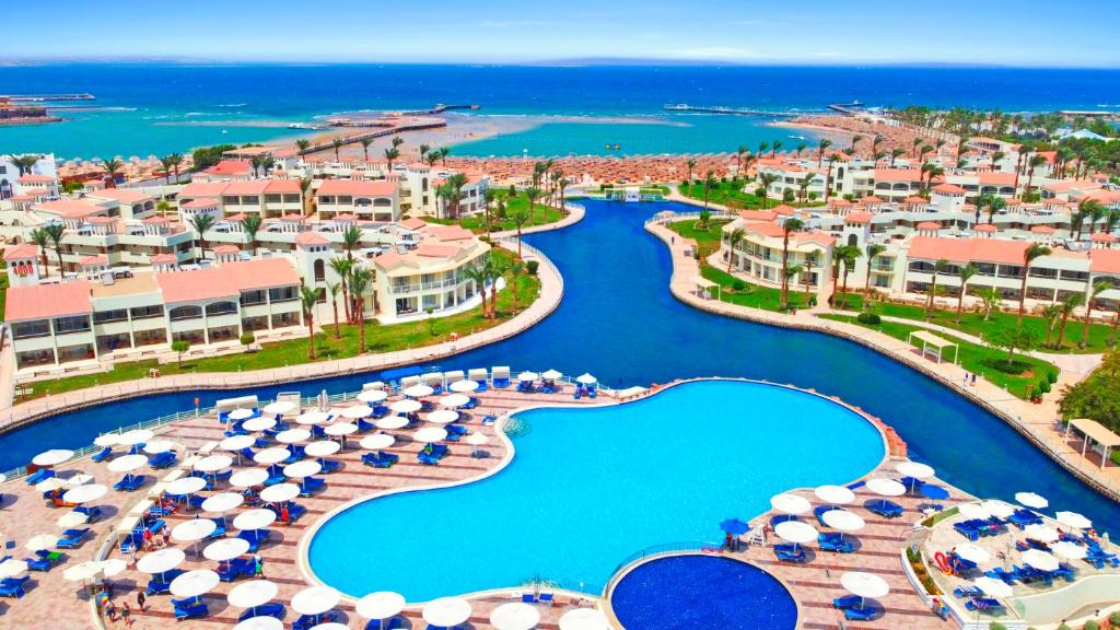 an aerial view of a resort with a pool and umbrellas at Pickalbatros Dana Beach Resort - Aqua Park in Hurghada
