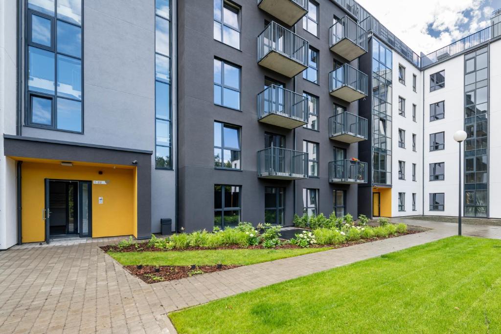 an apartment building with a lawn in front of it at Kaunas City Center Apartment in Kaunas